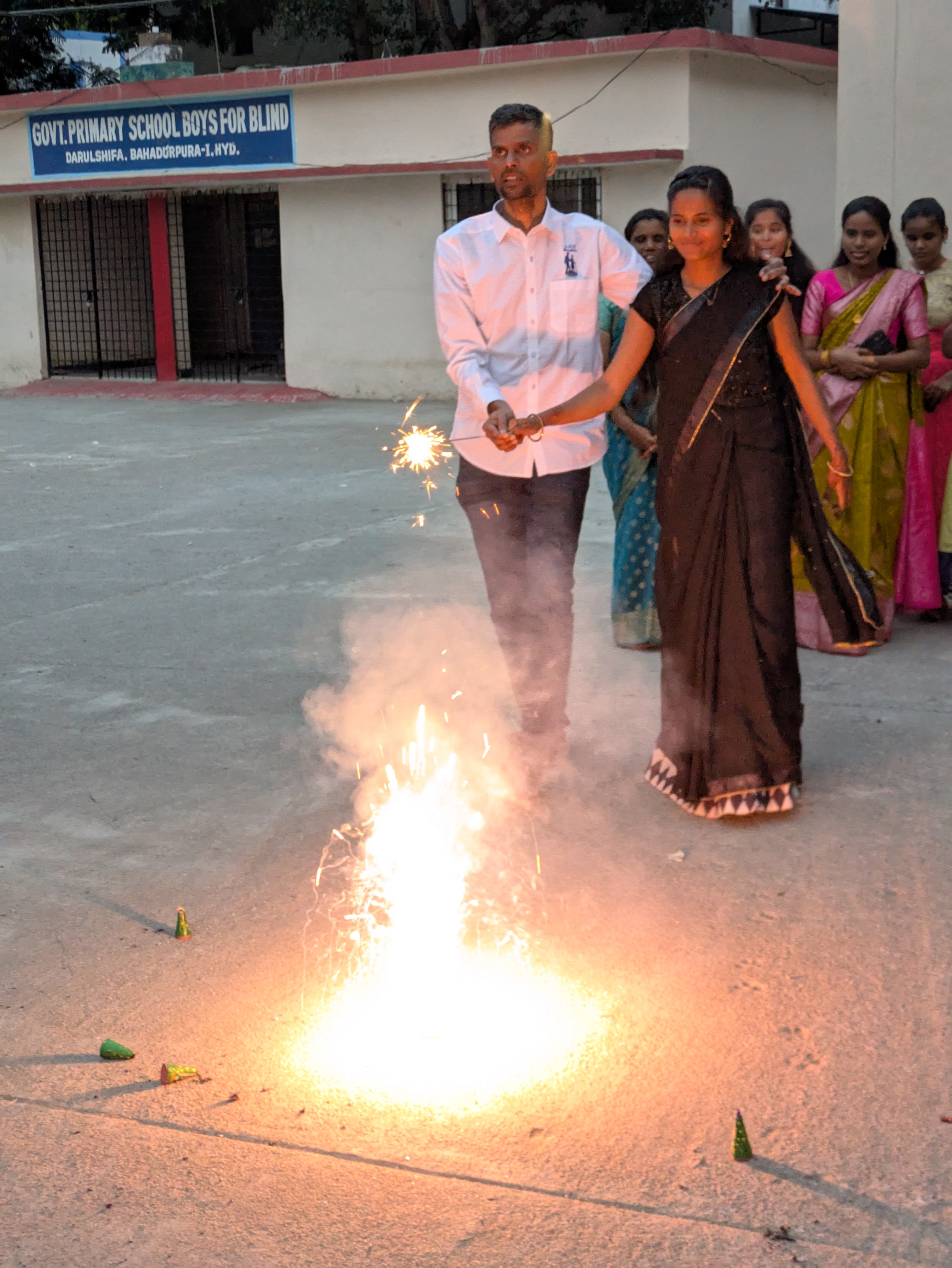 Children enjoying Diwali festivities with sparklers and sweets