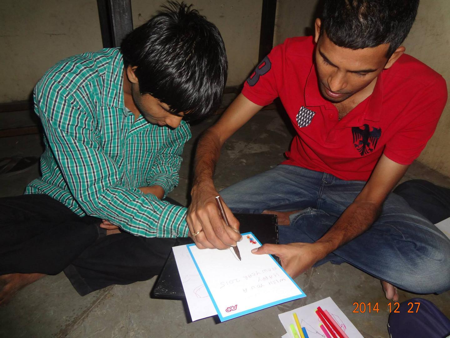 Volunteer helping a student learn to write